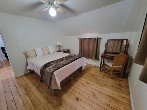 a bedroom with a bed and a chair and a table at Mallory Estate in Chariton