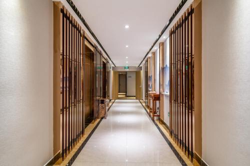 a hallway of a building with metal gates at Guangzhou Boyi Hotel in Guangzhou