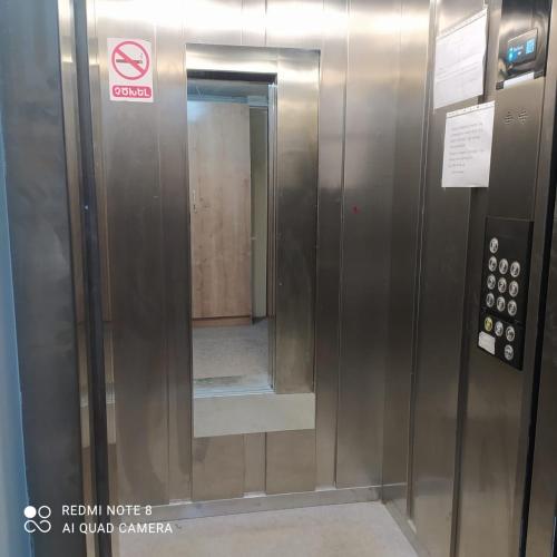 an elevator with a mirror in a building at Apartment in Yerevan komitas K1 in Yerevan