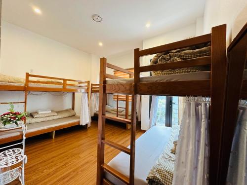 a room with three bunk beds in a building at Primrose Homestay Cao Bang in Cao Bằng