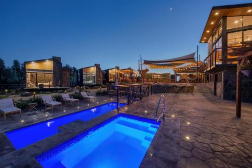 a swimming pool in front of a house at night at Sirius Valle in Valle de Guadalupe