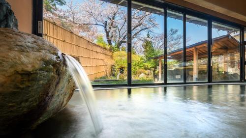 a water fountain in front of a building at Ichiraku tendo spa & brewery in Tendo