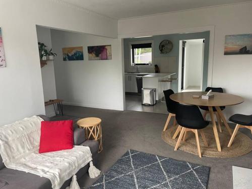 a living room with a couch and a table at Little White House on Ecclestone, Riverside in Alanvale