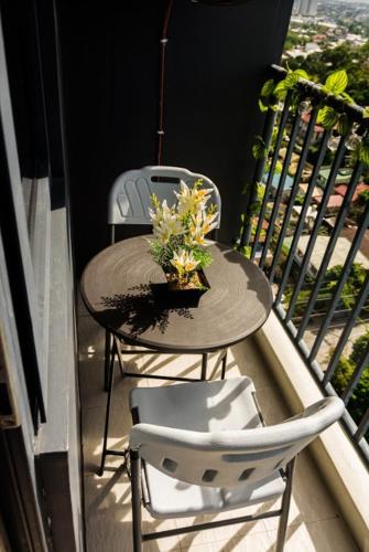a small table and two chairs on a balcony at 1 bedroom condo unit at Sundance Residences in Cebu City
