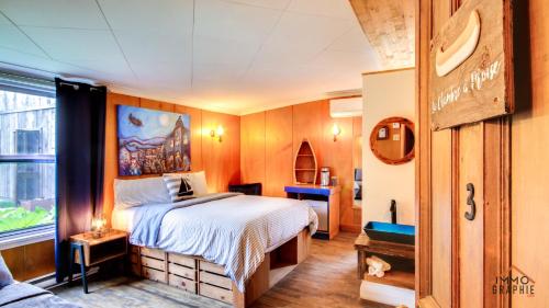 een slaapkamer met een bed en een raam bij Maison Cadorette in Saint-Jean-des Piles