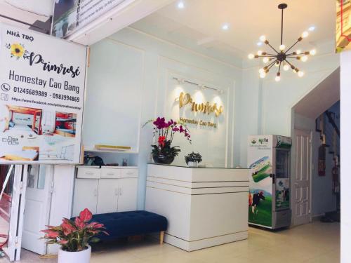 a room with a counter with flowers and a refrigerator at Primrose Homestay Cao Bang in Cao Bằng