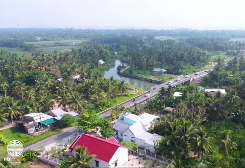 an aerial view of a town with a river and palm trees at HOMESTAY HT in Vĩnh Long