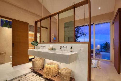 a bathroom with a sink and a large mirror at Tropical Seaview Villa with Pool in Koh Samui 