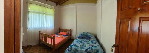 a small bedroom with a bed and a window at Betania House in Drake