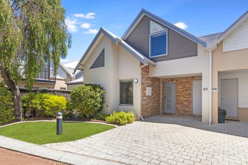 a house with a driveway in front of it at Tides at 65 Cape View Resort in Broadwater