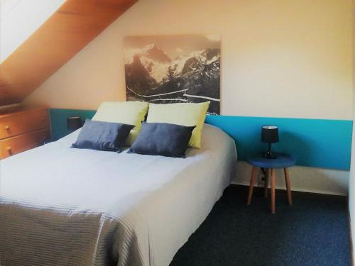 a bedroom with a large white bed with blue walls at Appart Duplex 8 pers avec Terrasse à Pra-Loup - FR-1-165A-170 in Uvernet-Fours