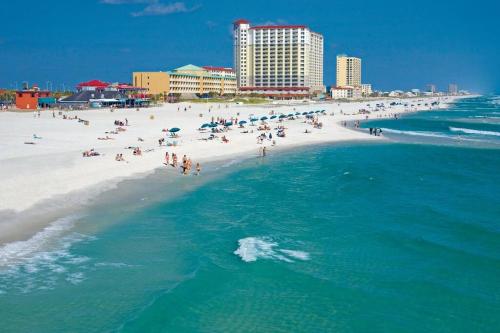 an aerial view of a beach with a crowd of people at Very Private 3 Bed Home with HEATED Pool Palms and Big Fenced Yard in Pensacola