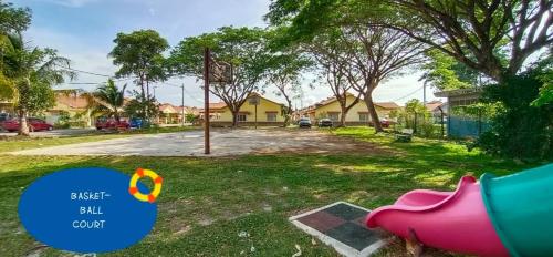 a backyard with a pink pig in the grass at OCEAN THIRTY # 15 mins to KLIA KLIA2 # with 2 Airconds & Wi-Fi in Banting