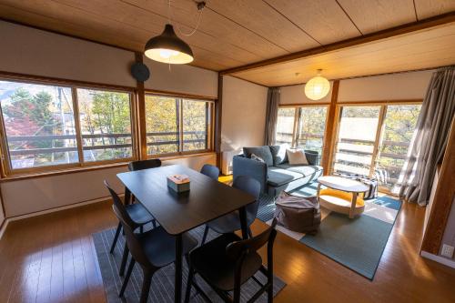 a living room with a table and a couch at NORTHSTAR Loft in Matsumoto