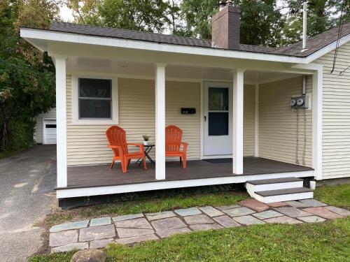 a porch with two chairs and a table on it at Cozy studio, minutes from downtown. Quiet. in South Burlington