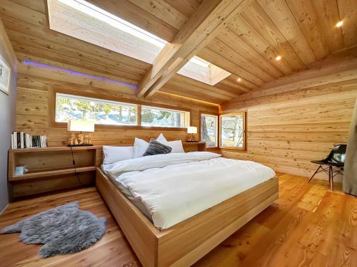 a bedroom with a large bed in a log cabin at Crans Montana under the stars in Crans-Montana