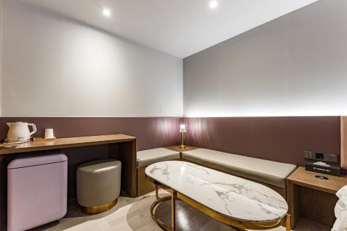 a small room with a bed and a table at Brown Dot Hotel Cheonan Buldang in Cheonan