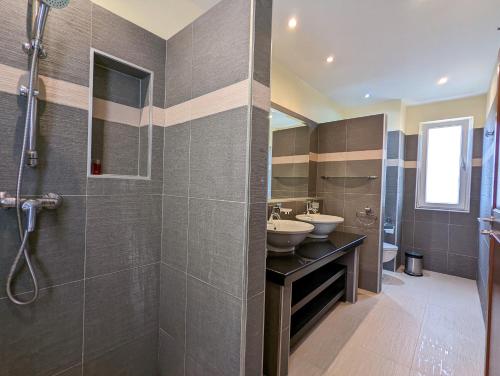 a bathroom with two sinks and a shower at Blue Sky Pool Villa in Trat