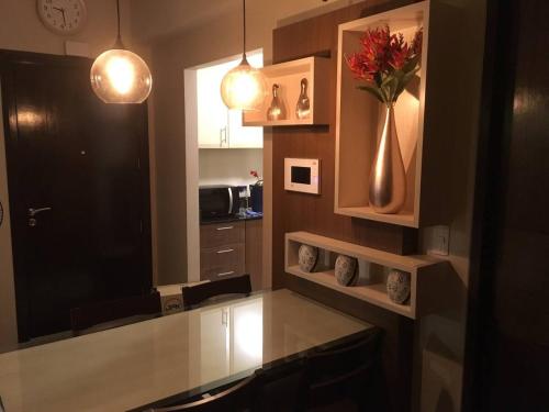 a kitchen with a counter with a vase of flowers at 2 BR Condo Apartment near NAIA 3 Pasay City in Manila