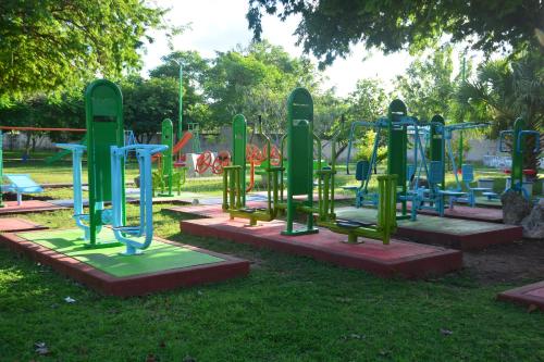 a playground with colorful equipment in a park at Casa Calis Cancún in Cancún