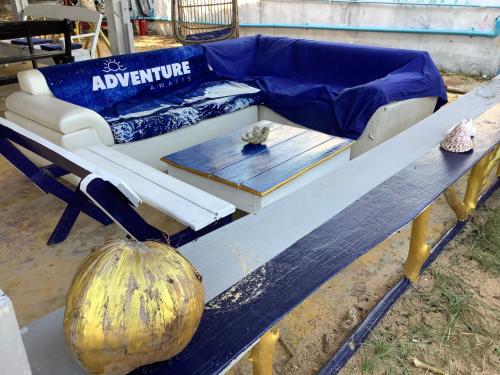 a table with a couch and a pumpkin on it at CocoHuts in Koh Rong Sanloem