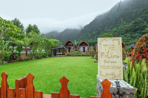 a sign in front of a yard with a house at The Polumb Garden Bedugul in Tabanan