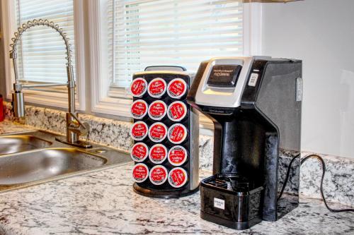 a coffee machine sitting on top of a kitchen counter at Brick Beauty Fayetteville 3 bedroom Mins from Downtown in Fayetteville