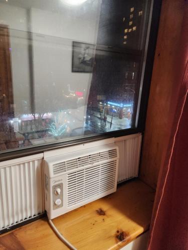 a room with a window and an air conditioner at In the heart of nyc! Time sq, theater district, javits center in New York