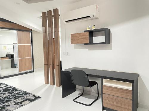 a office with a black desk and a chair at DZ Hotel Salor in Kota Bharu