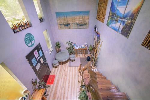 a living room with a wooden floor with plants at El Nido Family Room of hidden in El Nido