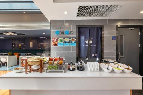 a kitchen with a counter with bowls of food on it at Holiday Inn Express Shenyang North Station by IHG in Shenyang