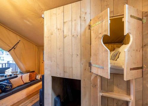 a tiny house with a bunk bed in it at Dovestone Holiday Park in Greenfield