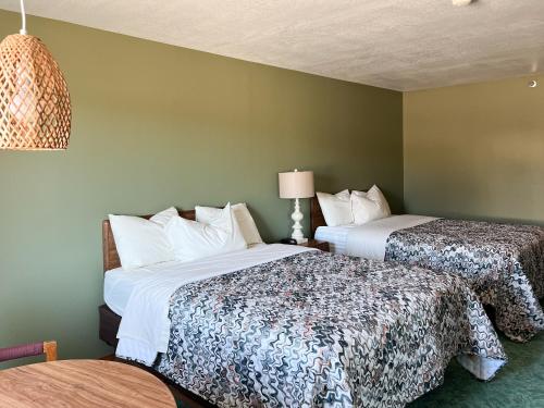 a hotel room with two beds in a room at The Trail Inn - Sutton, Nebraska - US-6 HWY in Sutton