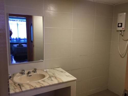 a bathroom with a sink and a mirror at Pd Bayu Beach Resort Apartment A2.16 in Port Dickson