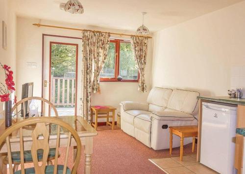 a living room with a couch and a table at Avalon Cottages in Llangynin