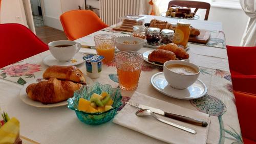 einen Tisch mit Frühstückszutaten und Getränken darauf in der Unterkunft Le clos du marronnier in Rivières-les-Fosses