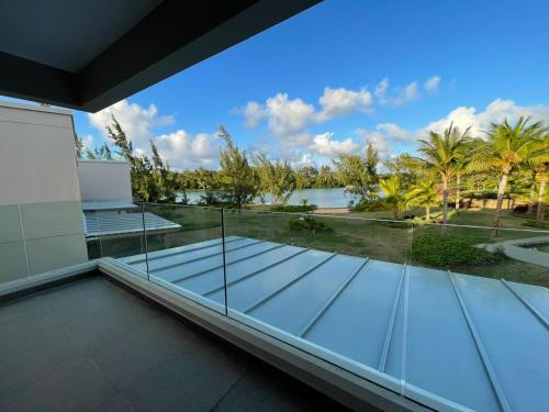 a glass balcony with a view of the water at Villa Barachois in Calodyne