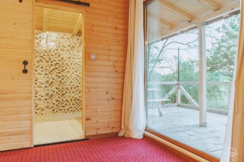 a room with a large window and a balcony at Zaga Zaga Sat in Tecuci