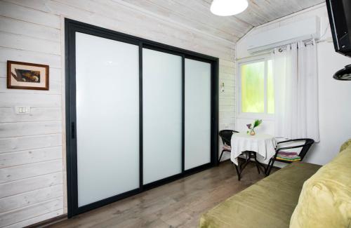 a room with sliding glass doors and a table at Galilaeaen Loft in Chorazim