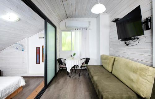 a living room with a couch and a table at Galilaeaen Loft in Chorazim