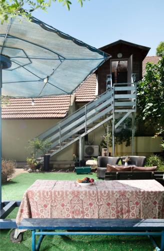 a patio with a table and chairs and a staircase at Galilaeaen Loft in Chorazim