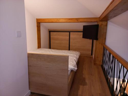 a small bedroom with a bed and a balcony at White Eagle Kopaonik - Beli Orao in Kopaonik