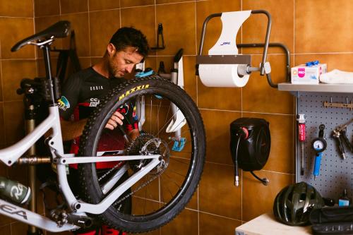 a man is holding a bike in a bathroom at Hotel Gran Sol in San Antonio
