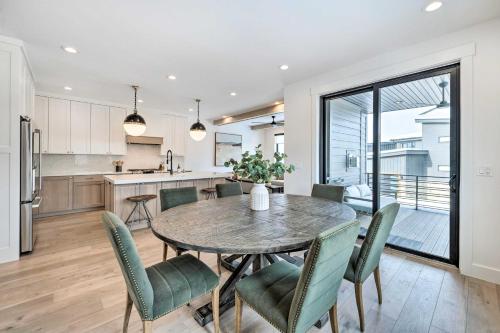 a kitchen and dining room with a table and chairs at Mountain-View Townhome Near Powder Mountain! in Huntsville