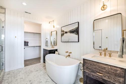 a white bathroom with a large tub and a sink at Mountain-View Townhome Near Powder Mountain! in Huntsville