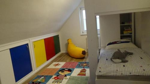 a childs bedroom with a bed and a toy banana at Villa Strandräuber in Zudar