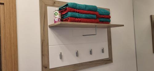 a mirror in a bathroom with a pile of towels at Doxa Airport Otopeni in Otopeni