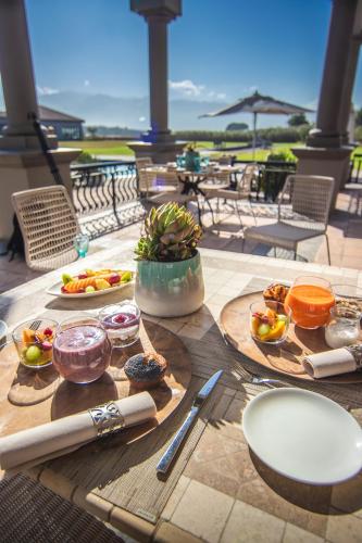 a table with plates of food on top at Santé Wellness Retreat & Spa in Paarl