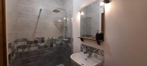 a bathroom with a shower and a sink at Le Fort d'Issigeac Chambres d'Hôtes in Issigeac