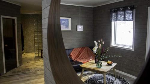 a living room with a couch and a table at Aurora Cone in Kiruna